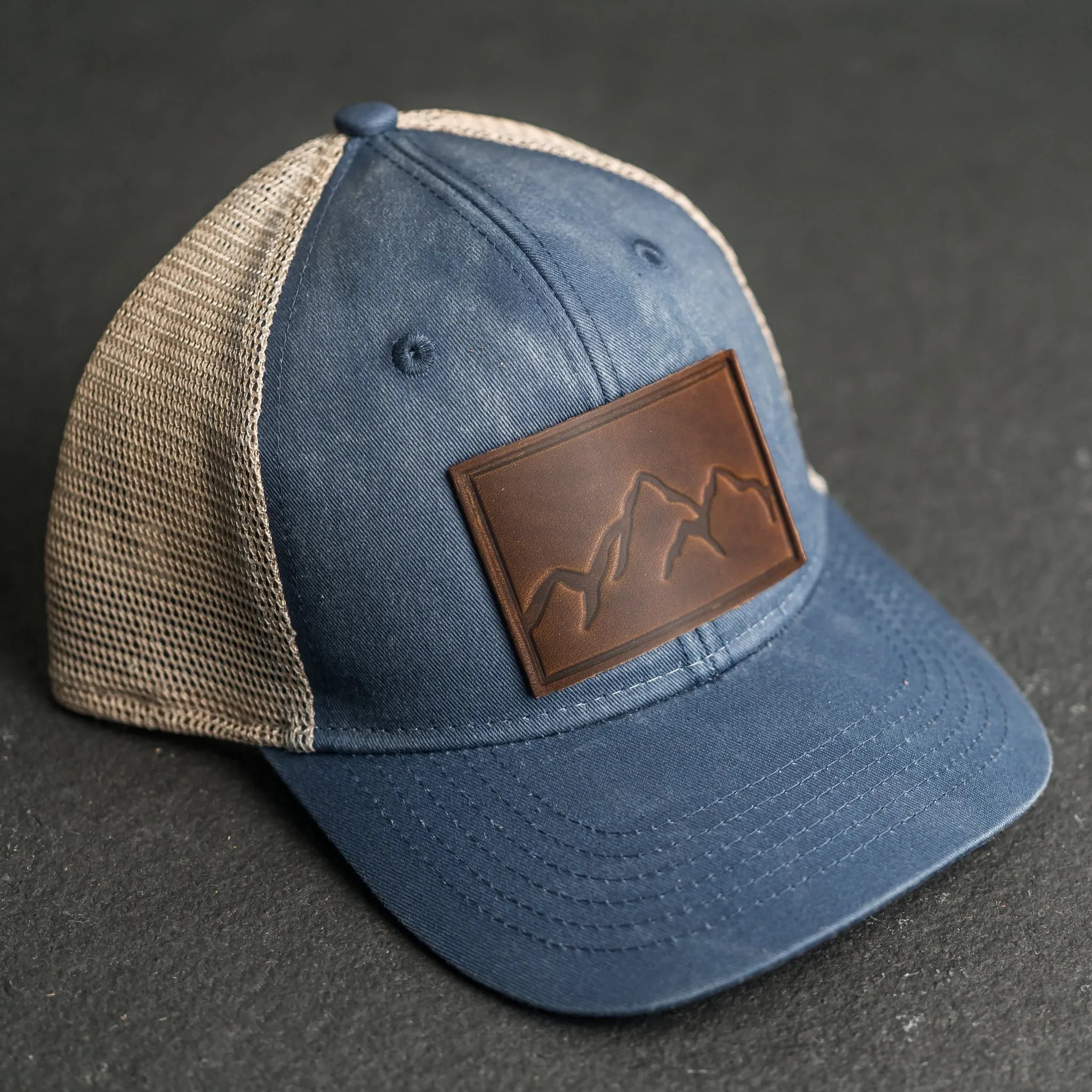 Leather Patch Ponytail Style Hat - Mountain Range Stamp